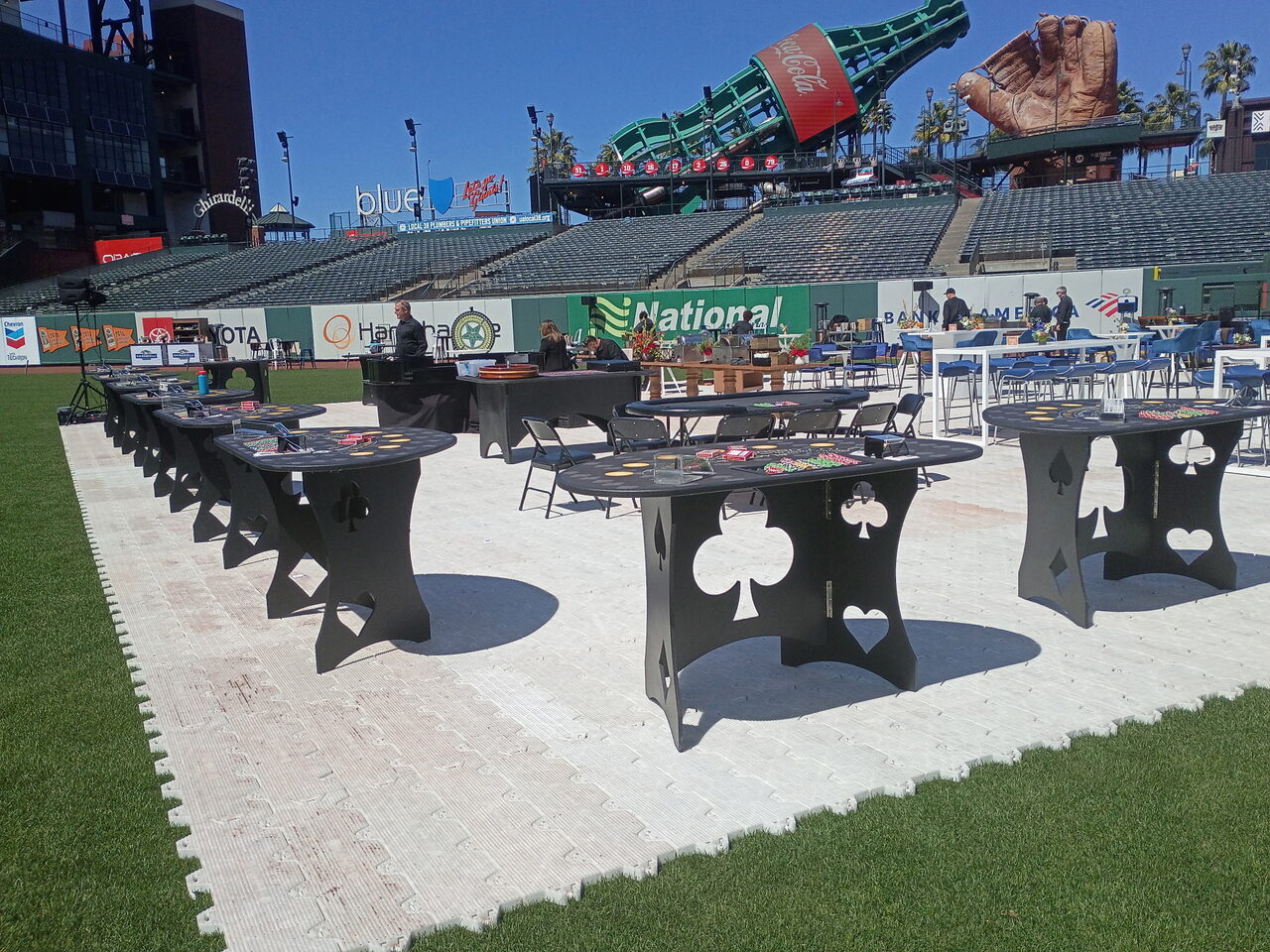 Custom spade and club casino tables set up at a Sacramento gala venue