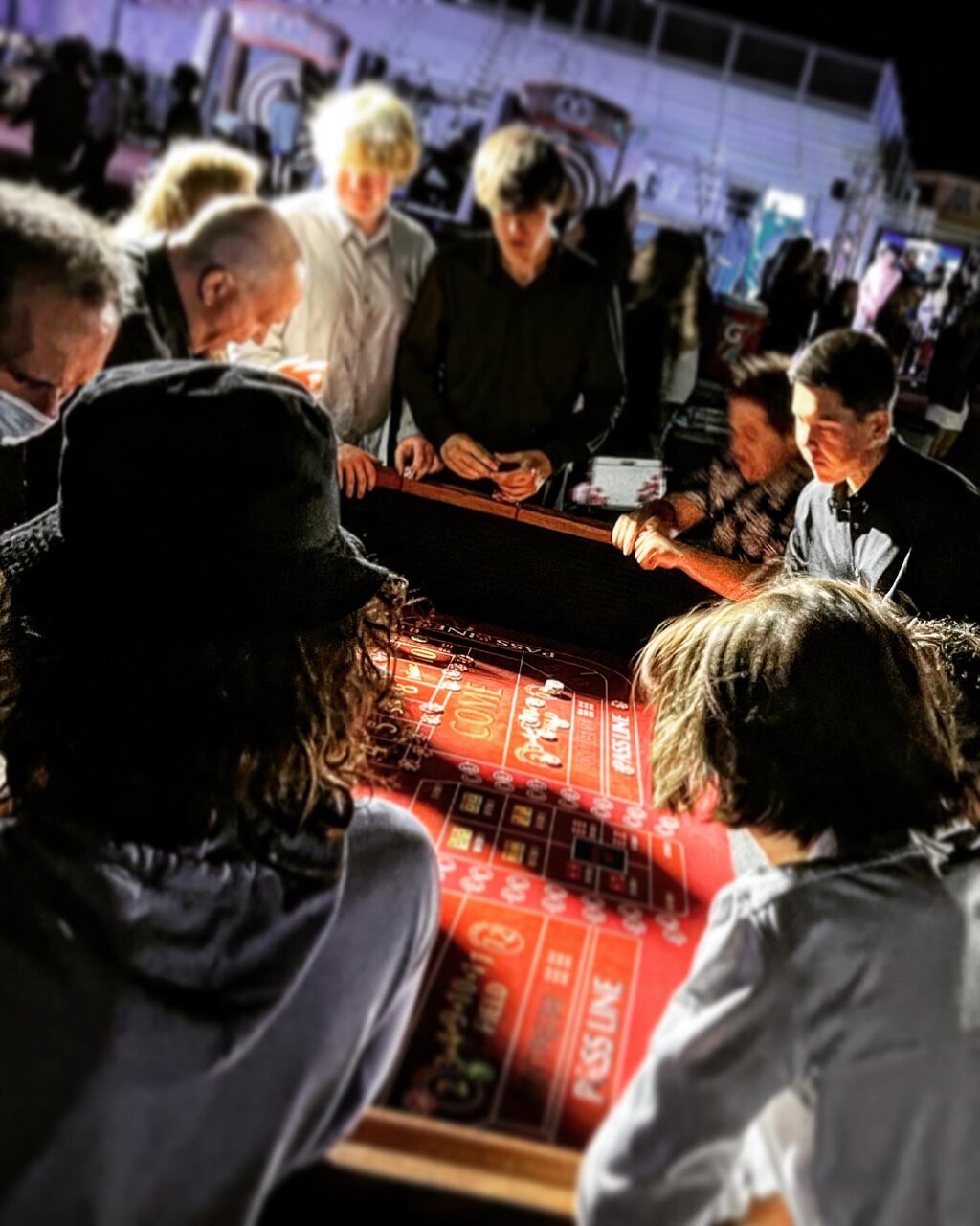 Packed casino party with guests crowding the gaming tables in Sacramento